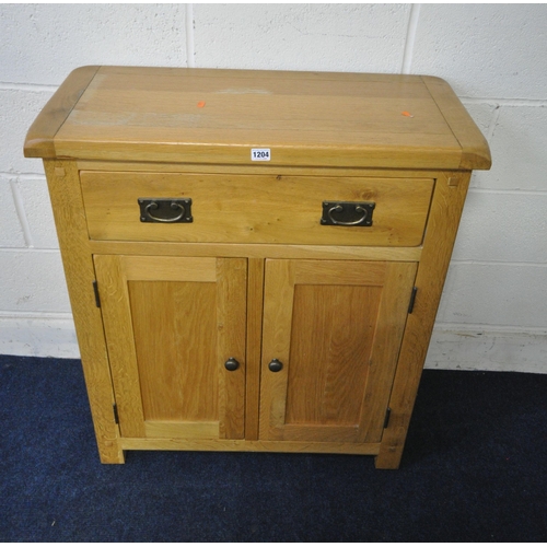 1204 - A MODERN SOLID OAK CABINET, with a single drawer, above double cupboard doors, width 79cm x depth 36... 