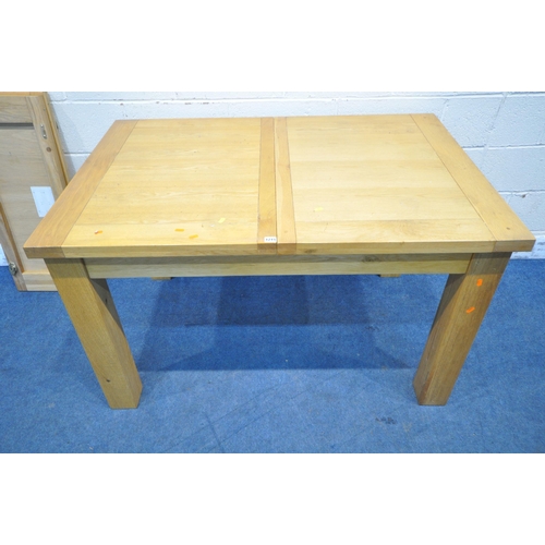 1215 - A MODERN SOLID OAK RECTANGULAR EXTENDING DINING TABLE, raised on block legs, with two leaves, extend... 