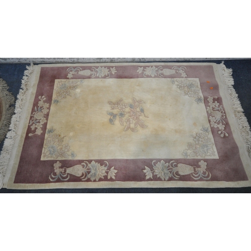 1216 - A CREAM GROUND RECTANGULAR CHINESE WOOLEN RUG, with foliate design, and a border, 200cm x 122cm, alo... 