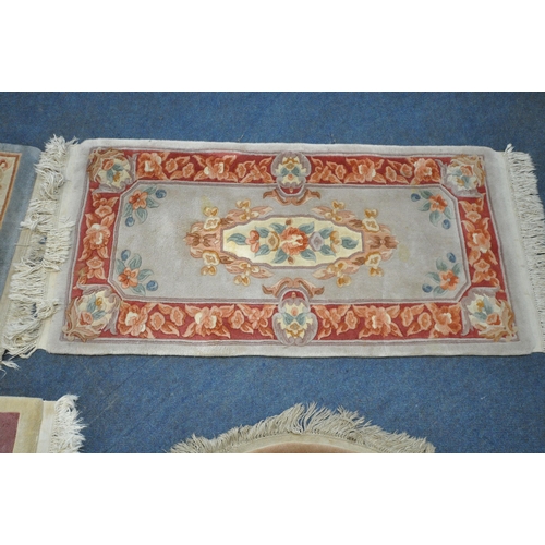 1216 - A CREAM GROUND RECTANGULAR CHINESE WOOLEN RUG, with foliate design, and a border, 200cm x 122cm, alo... 