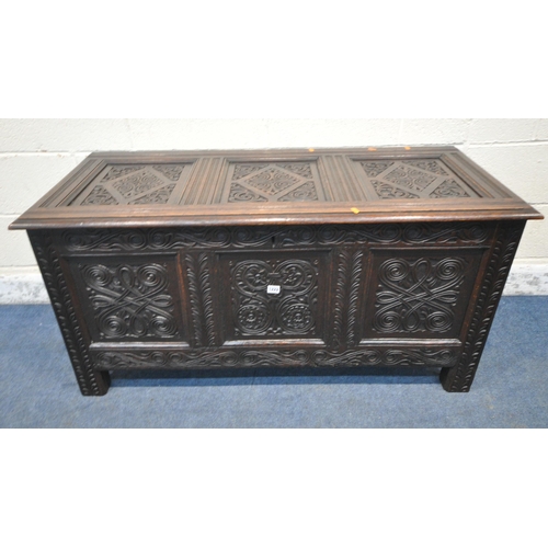 1222 - A GEORGIAN AND LATER OAK COFFER, the panels with scrolled and geometric carvings, width 126cm x dept... 