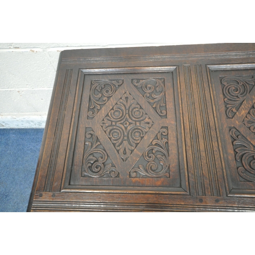 1222 - A GEORGIAN AND LATER OAK COFFER, the panels with scrolled and geometric carvings, width 126cm x dept... 