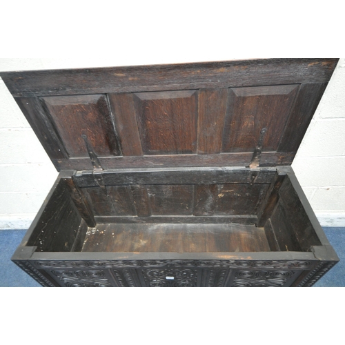 1222 - A GEORGIAN AND LATER OAK COFFER, the panels with scrolled and geometric carvings, width 126cm x dept... 