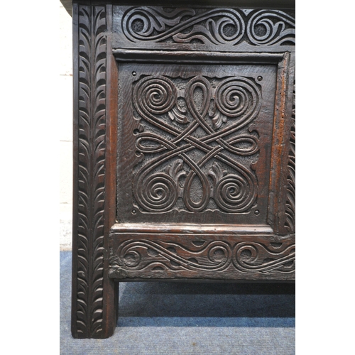 1222 - A GEORGIAN AND LATER OAK COFFER, the panels with scrolled and geometric carvings, width 126cm x dept... 