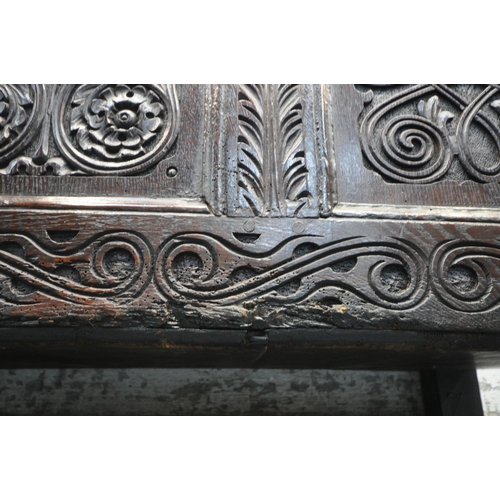 1222 - A GEORGIAN AND LATER OAK COFFER, the panels with scrolled and geometric carvings, width 126cm x dept... 