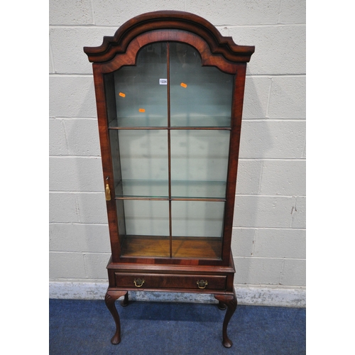 1224 - A REPRODUCTION MAHOGANY DISPLAY CABINET, with a stepped arched top, the single glazed door enclosing... 