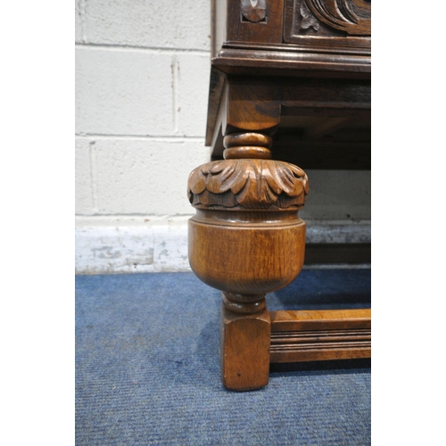 1225 - A 20TH CENTURY SOLID OAK FOUR DOOR CUPBOARD, each door with two panels depicting the Tudor rose, abo... 