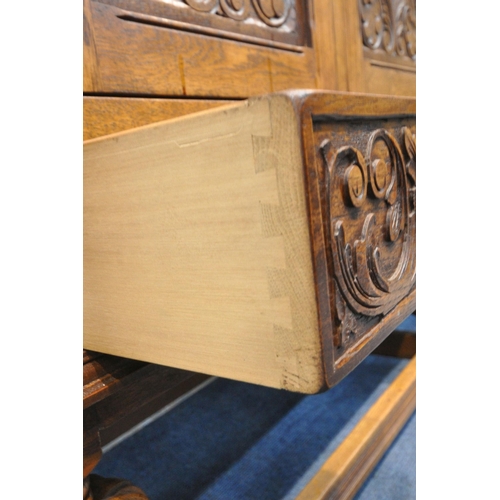 1225 - A 20TH CENTURY SOLID OAK FOUR DOOR CUPBOARD, each door with two panels depicting the Tudor rose, abo... 