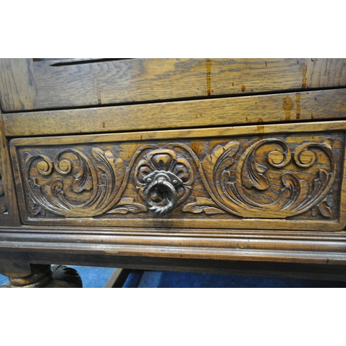 1225 - A 20TH CENTURY SOLID OAK FOUR DOOR CUPBOARD, each door with two panels depicting the Tudor rose, abo... 