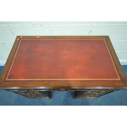 1226 - A 20TH CENTURY MAHOGANY TWIN PEDESTAL DESK, with oxblood leather writing surface, fitted with nine a... 