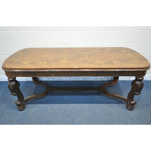 1231 - A 20TH CENTURY BURR WALNUT TABLE, with rounded ends, raised on four scrolled legs, with bun feet, un... 