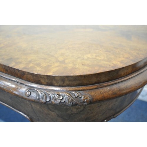 1231 - A 20TH CENTURY BURR WALNUT TABLE, with rounded ends, raised on four scrolled legs, with bun feet, un... 