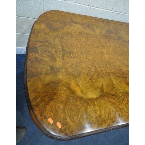 1231 - A 20TH CENTURY BURR WALNUT TABLE, with rounded ends, raised on four scrolled legs, with bun feet, un... 