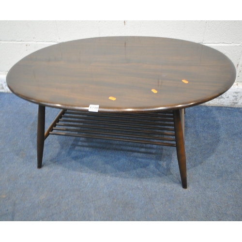 1239 - LUCIAN ERCOLANI, A MID CENTURY DARK ELM AND BEECH OVAL COFFEE TABLE, raised on cylindrical tapered l... 