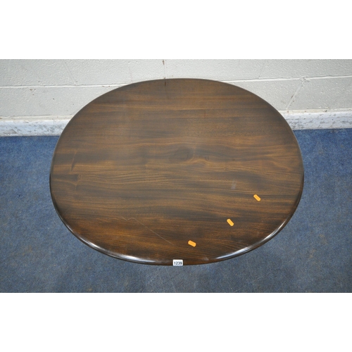 1239 - LUCIAN ERCOLANI, A MID CENTURY DARK ELM AND BEECH OVAL COFFEE TABLE, raised on cylindrical tapered l... 