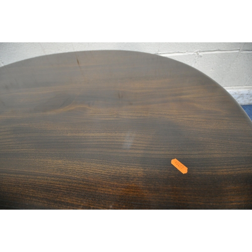 1239 - LUCIAN ERCOLANI, A MID CENTURY DARK ELM AND BEECH OVAL COFFEE TABLE, raised on cylindrical tapered l... 