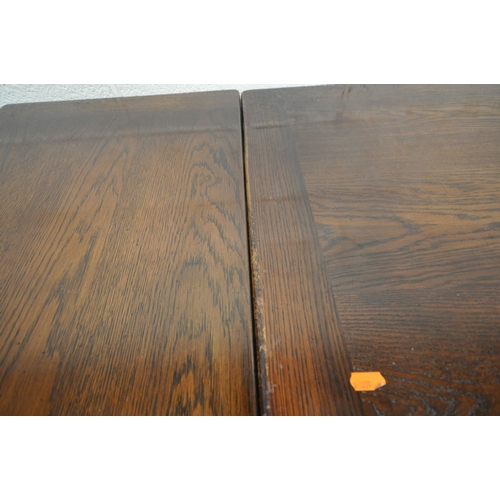 1246 - A 20TH CENTURY OAK DRAW LEAF DINING TABLE, raised on acorn style supports, with shaped feet, united ... 