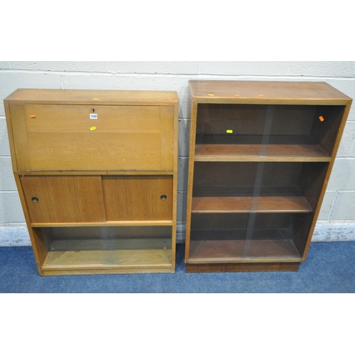 1249 - AN ODHAMS SOLIDA OAK BUREAU, the fall front door enclosing a fitted interior, above double sliding c... 