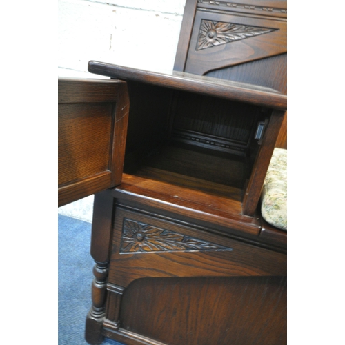 1250 - A LATE 20TH CENTURY OAK TELEPHONE TABLE, with a small cupboard door, and a hinged seat, width 94cm x... 