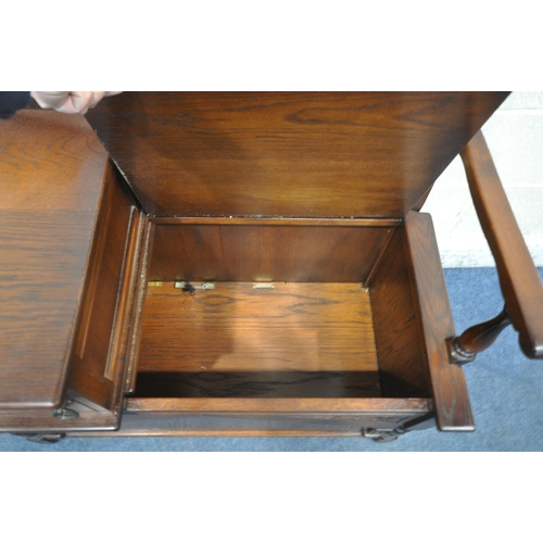 1250 - A LATE 20TH CENTURY OAK TELEPHONE TABLE, with a small cupboard door, and a hinged seat, width 94cm x... 