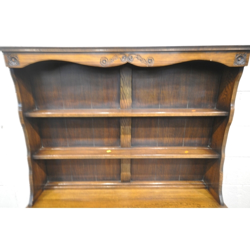 1251 - A LATE 20TH CENTURY OAK DRESSER, the two tier plate rack, atop a base with two drawers, above double... 