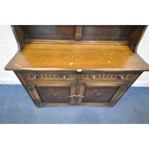 1251 - A LATE 20TH CENTURY OAK DRESSER, the two tier plate rack, atop a base with two drawers, above double... 