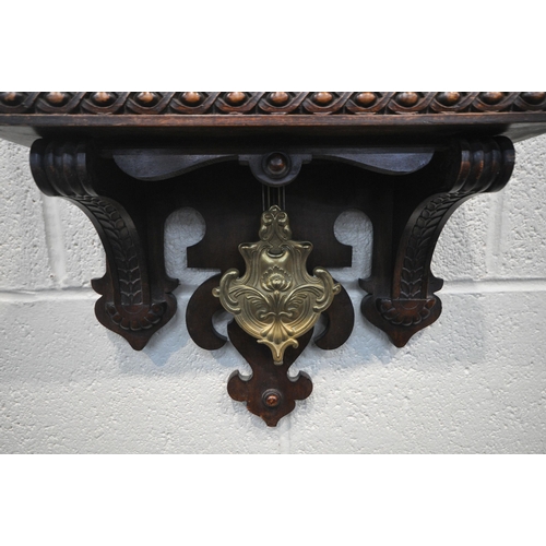 1261 - A 20TH CENTURY OAK WALL CLOCK, eagle pediment, flanked by twin finials, the door enclosing a 7 inch ... 