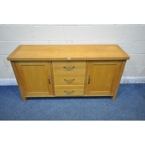 1266 - A MODERN SOLID OAK SIDEBOARD, fitted with three drawers, flanked by two cupboard doors, width 152cm ... 