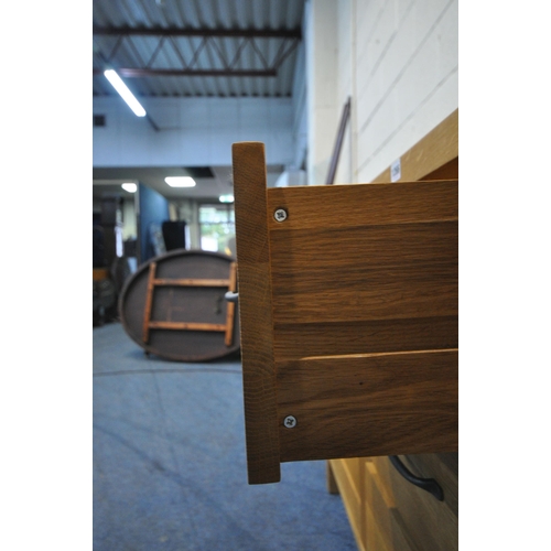 1266 - A MODERN SOLID OAK SIDEBOARD, fitted with three drawers, flanked by two cupboard doors, width 152cm ... 