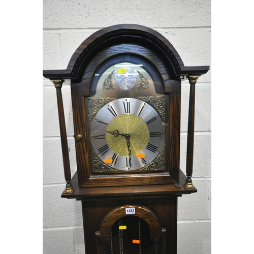 1283 - TEMPUS FUGIT, A 20TH CENTURY OAK LONGCASE CLOCK, the arched good with a glass door, that's enclosing... 