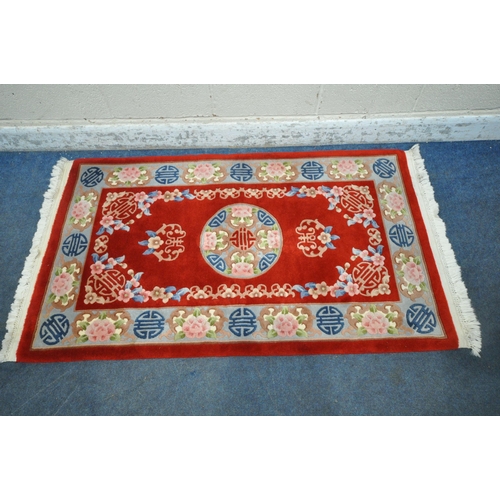 1291 - A RED GROUND RECTANGULAR CHINESE WOOLEN RUG, 170cm x 95cm (condition report: ideal for a clean)