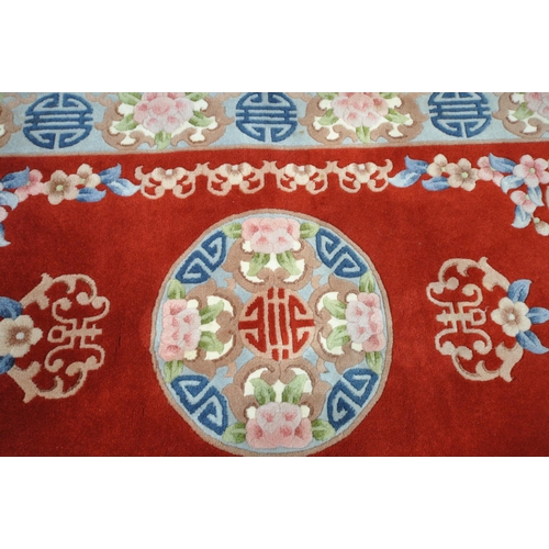 1291 - A RED GROUND RECTANGULAR CHINESE WOOLEN RUG, 170cm x 95cm (condition report: ideal for a clean)