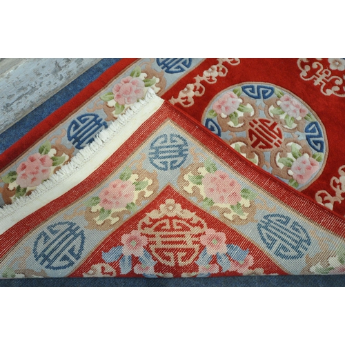 1291 - A RED GROUND RECTANGULAR CHINESE WOOLEN RUG, 170cm x 95cm (condition report: ideal for a clean)