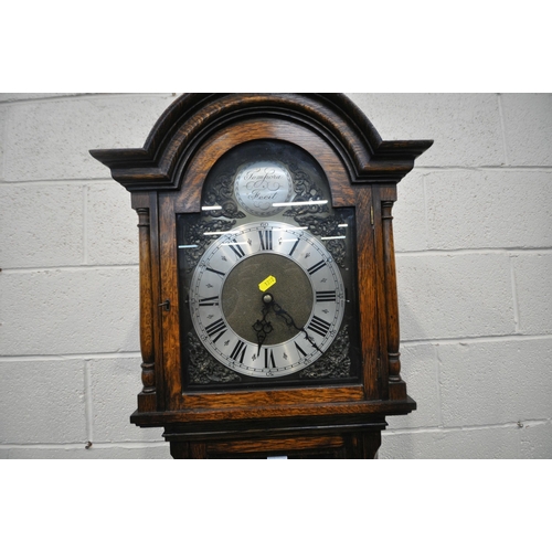 1292 - A 20TH CENTURY OAK LONGCASE CLOCK, the arched glass door enclosing a 9.5 inch brass and silvered dia... 