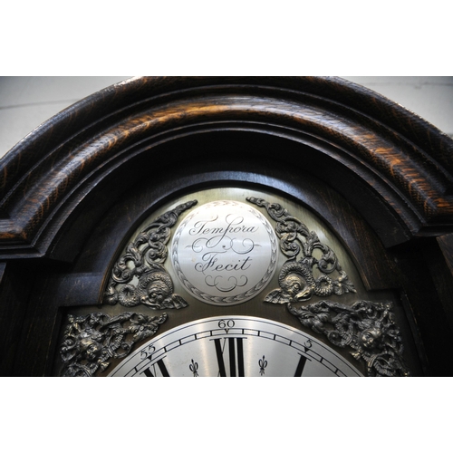 1292 - A 20TH CENTURY OAK LONGCASE CLOCK, the arched glass door enclosing a 9.5 inch brass and silvered dia... 