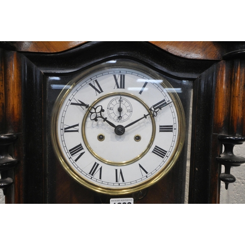 1293 - A VICTORIAN STYLE WALNUT VIENNA WALL CLOCK, the glass door enclosing a 7 inch brass and enamel dial,... 