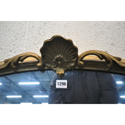 1296 - AN ARCHED GILT FRAME OVERMANTEL MIRROR, with scrolled and foliate details, width 103cm x 113cm (cond... 