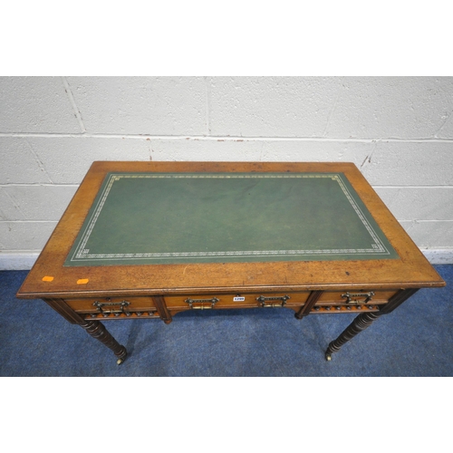 1299 - AN EDWARDIAN WALNUT DESK, with a green leather writing surface, three frieze drawers, turned and tap... 