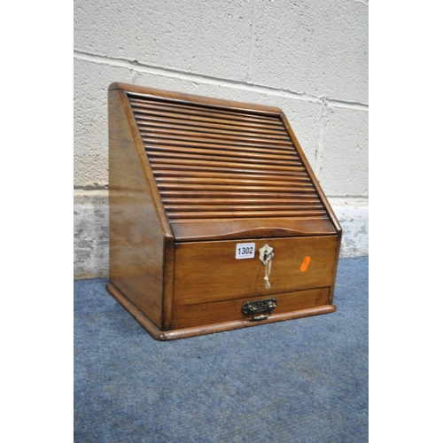 1302 - AN EARLY 20TH CENTURY MAHOGANY STATIONARY CABINET, with a tambour door, that's enclosing a fitted in... 