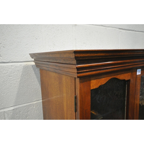 1304 - A 20TH CENTURY MAHOGANY CABINET ON STAND, with double glazed doors, raised on square tapered legs, w... 