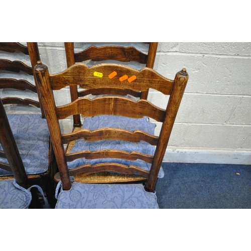 1310 - A HARLEQUIN SET OF EIGHT EARLY 20TH CENTURY OAK LADDERBACK CHAIRS, with rush seats, raised on turned... 