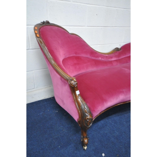 1312 - A VICTORIAN WALNUT CHAISE LONGUE, with a carved frame, and pink upholstery, length 187cm x depth 84c... 