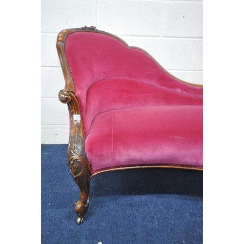 1312 - A VICTORIAN WALNUT CHAISE LONGUE, with a carved frame, and pink upholstery, length 187cm x depth 84c... 