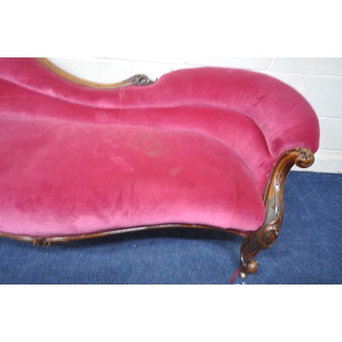 1312 - A VICTORIAN WALNUT CHAISE LONGUE, with a carved frame, and pink upholstery, length 187cm x depth 84c... 