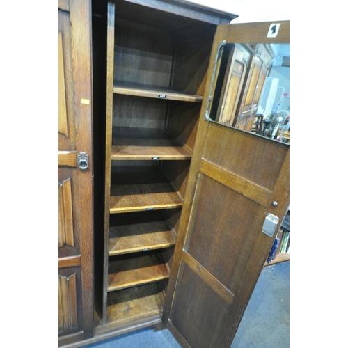 1321 - A 20TH CENTURY OAK TWO PIECE BEDROOM SUITE, comprising two sized linenfold double door wardrobes, la... 