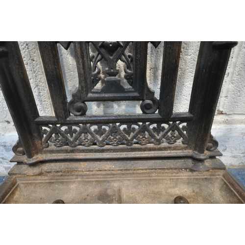 1329 - A VICTORIAN CAST IRON HALL STAND, with an arrangement of rails and pegs, a small circular mirror, re... 