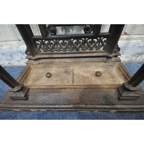 1329 - A VICTORIAN CAST IRON HALL STAND, with an arrangement of rails and pegs, a small circular mirror, re... 