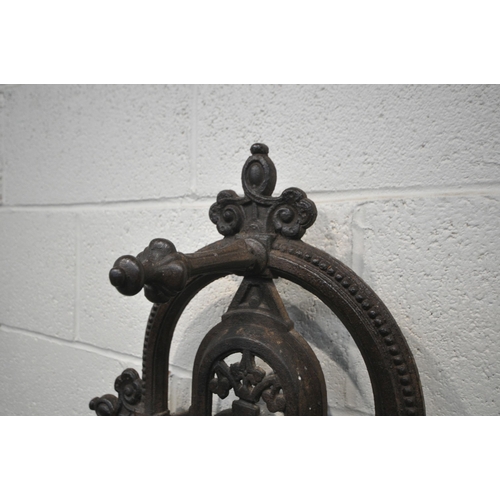 1329 - A VICTORIAN CAST IRON HALL STAND, with an arrangement of rails and pegs, a small circular mirror, re... 