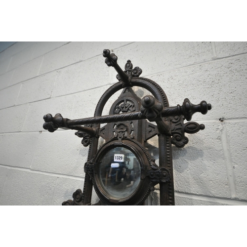 1329 - A VICTORIAN CAST IRON HALL STAND, with an arrangement of rails and pegs, a small circular mirror, re... 