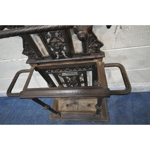 1329 - A VICTORIAN CAST IRON HALL STAND, with an arrangement of rails and pegs, a small circular mirror, re... 